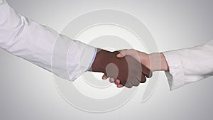 Medical handshake on gradient background.