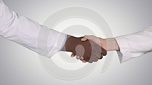 Medical handshake on gradient background.