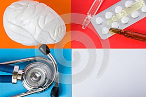 Medical or health care design concept photo-organ brain, diagnostic medical tool stethoscope and medications pills and vials