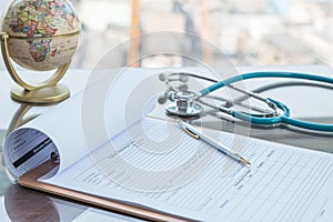 Medical health care record, patients discharge, or prescription form paperwork in hospital clinic with doctor`s stethoscope