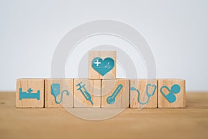 medical and health  insurance, world health day concept. Blue  health icon on wooden cube blocks with heart icon on top