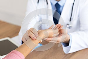 Doctor checking measuring pressure on patient`s hand pulse