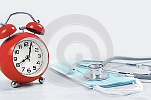 Medical or healthcare concept. stethoscope and spiral notepads with alarm clock