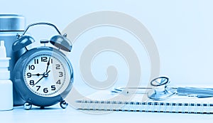 Medical or healthcare concept. stethoscope and spiral notepads with alarm clock