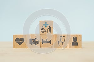 medical healthcare, health insurance, elderly care concept. medical and health icon on wooden cube block
