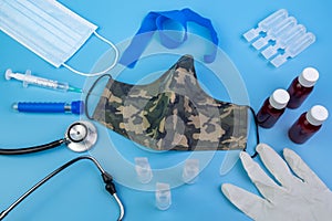 Medical and healthcare instruments and consumables with a military green mask photo