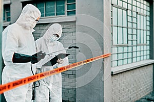 Medical healthcare workers working together against the spread of covid virus, while wearing protective clothing