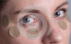 Medical herbal patch for the girl around the eyes to remove bags under the eyes and improve vision, macro