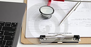 Medical history of patient with ballpoint pen and stethoscope lying on table near laptop 4k movie