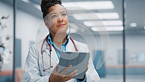 Medical Hospital Portrait: Confident African American Female Medical Doctor Using Digital Tablet