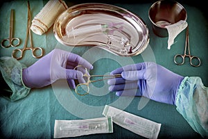 Medical and instrumentalist nurse working in an operating room with scissors of surgery