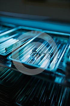 Medical instruments being sterilized under a ultraviolet autoclave.