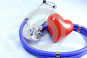 Medical instruments, stethoscope and red heart closeup shot