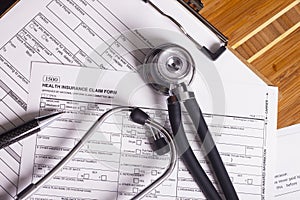 Medical insurance records, pen and Stethoscope