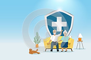 Medical insurance for senior healthcare protection. Happy elderly couple on sofa with medical shield. Healthy aging and senior