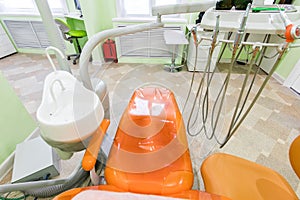 Medical interior, dental office with an orange chair, lamp and equipment. stomatology concept