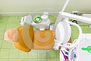 Medical interior, dental office with an orange chair, lamp and equipment. stomatology concept top view