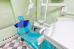 Medical interior, dental x-ray office with a blue chair, lamp and equipment. stomatology concept