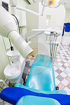 Medical interior, dental x-ray office with a blue chair, lamp and equipment. stomatology concept