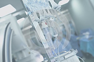 Medical IV drip systems on a background of the operating room