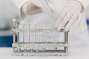 Medical laboratory scientists holding a test tube with sample