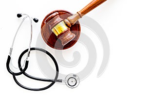 Medical law, health law concept. Gavel and stethoscope on white backgound top view copy space