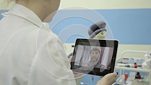 Medical on-line consultations. male senior patient video chatting with doctor on pc tablet