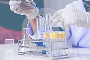 Medical or male medical in laboratory room research performs tests with blue liquid,