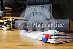 Medical malpractice documents on a table.