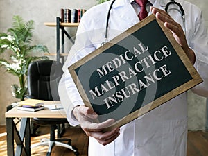 Medical malpractice insurance or professional liability concept. Doctor with blackboard.