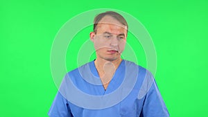 Medical man in anticipation of worries, then disappointed and upset. Green screen