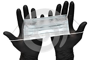 Medical man holds antivirus face mask in hands in black medical gloves. Isolated on white background