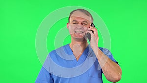 Medical man talking for mobile phone and rejoice. Green screen