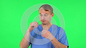 Medical man talking and pointing side hand for something, copy space. Green screen