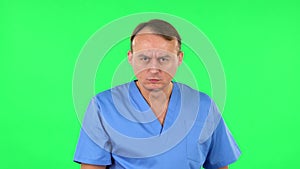 Medical man threatens with a finger and waves her head negatively. Green screen