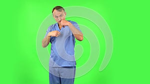 Medical man waving hand and showing gesture come here. Green screen