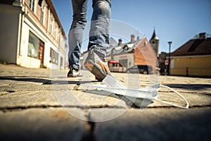 Medical mask against coronavirus lying on the ground