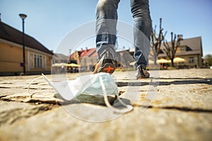 Medical mask against coronavirus lying on the ground