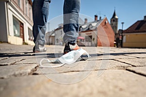 Medical mask against coronavirus lying on the ground