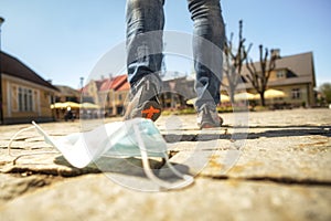 Medical mask against coronavirus lying on the ground