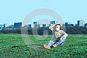 Medical mask as protection against coronavirus. guy sits in a clearing away from the city hiding from the coronavirus