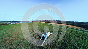 Medical mask as protection against coronavirus. guy is sitting in a clearing near the lake hiding from the coronavirus