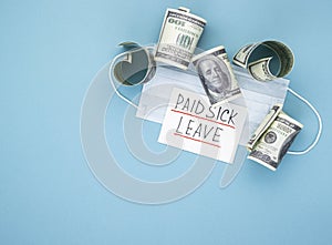 Medical mask with dollars and the words paid sick leave on a blue background