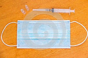 Medical mask with ear straps on white background. Medical tools health professionals.Disposable syringes