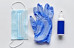 medical mask, gloves and hand sanitizer in spray photo