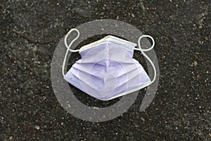 Medical mask lies on road. Mask to protect against virus