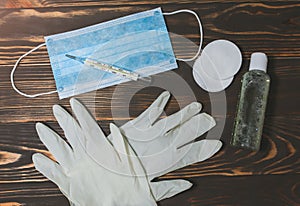 Medical mask and mercury thermometer. Antiseptic and cotton pads with rubber gloves. Virus illness. Coronavirus pandemia danger.