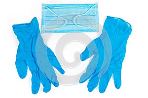 Medical mask and nitrile gloves on white background, top view
