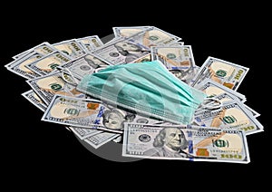 Medical mask on a pile of american dollars