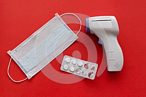 Medical mask, pills and non-contact thermometer.